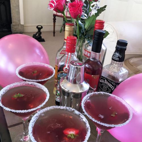 a table with three martini glasses and bottles of wine at The Paragon Townhouse in Bath