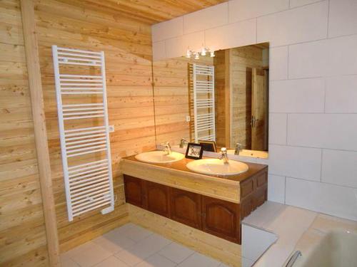a bathroom with two sinks and a mirror at Odalys Chalet Erika in Les Deux Alpes