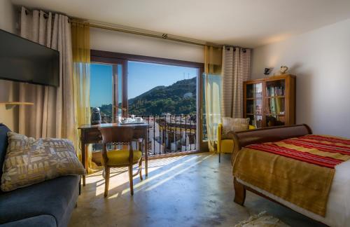 a bedroom with a bed and a table with a view at La Posada del Angel in Ojén