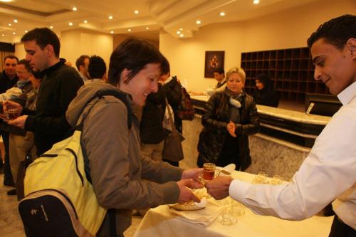 a man handing a woman a glass of wine at La Maison Hotel in Wadi Musa