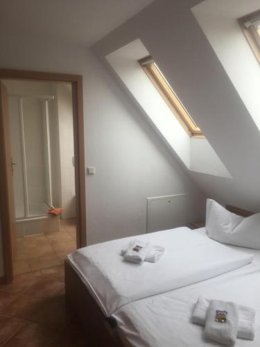 a bedroom with a white bed with towels on it at Kirchseeblick 6 in Kirchdorf