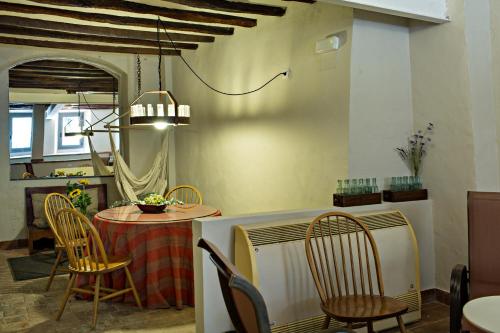 a dining room with a table and chairs at El Jardinet de Sant Esteve in Olot