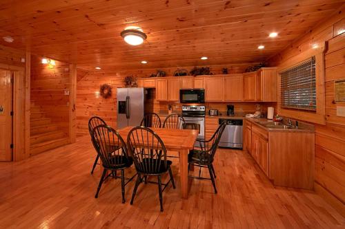 a kitchen with a table and chairs in a cabin at Natural Attractions in Gatlinburg