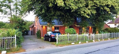 a car parked in front of a red brick house at Kieler FeWo No.2 in Kiel