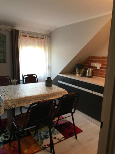 a kitchen with a table and chairs in a room at Fonfa Liget in Sénye