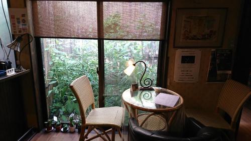 a table and chairs in a room with a window at Live Cafe Hisui no Umi in Itoigawa