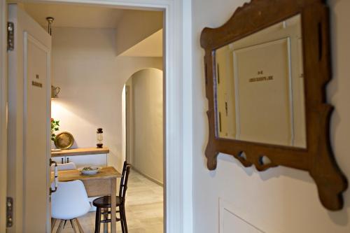 a mirror hanging on a wall next to a table at El Jardinet de Sant Esteve in Olot