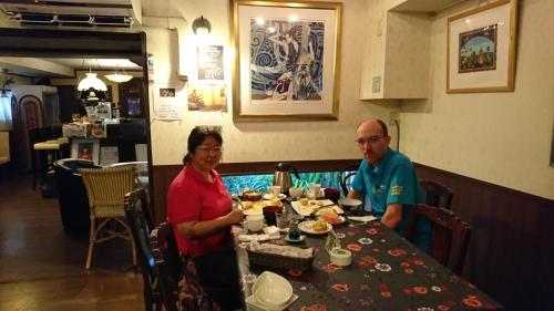a man and woman sitting at a table in a restaurant at Live Cafe Hisui no Umi in Itoigawa