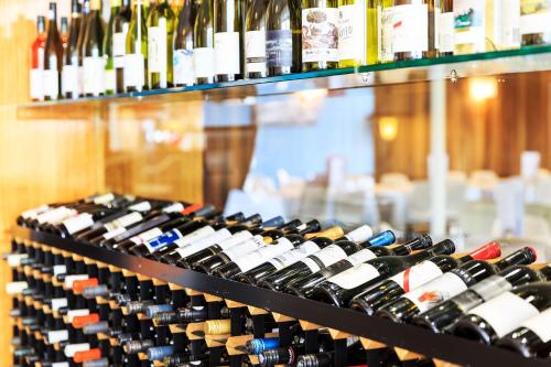 a bunch of bottles of wine on a shelf at Riverfront Motel & Restaurant in Hobart