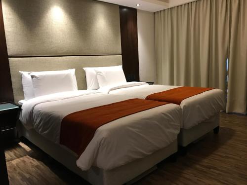 a bedroom with a large bed with a large headboard at Crystal Tower in Montevideo