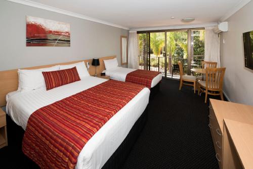 a hotel room with two beds and a balcony at Comfort Inn Grammar View in Toowoomba