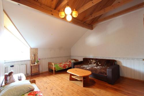 a living room with a couch and a table at Forest B&B in Krāslava