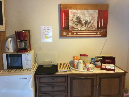 a kitchen counter with a microwave and a coffee maker at Privatzimmer / bed & breakfast in Andermatt