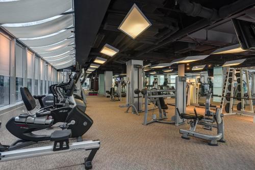 a gym with lots of treadmills and exercise bikes at Regal Airport Hotel in Hong Kong