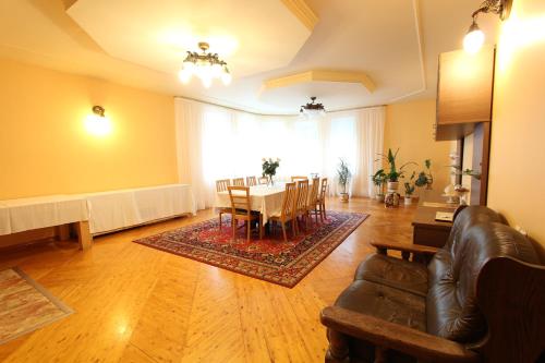 a living room with a table and a dining room at Forest B&B in Krāslava