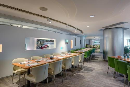 a dining room with long tables and chairs at Regal Airport Hotel in Hong Kong