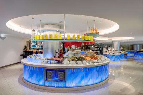 a food counter in a restaurant with food on it at Regal Airport Hotel in Hong Kong