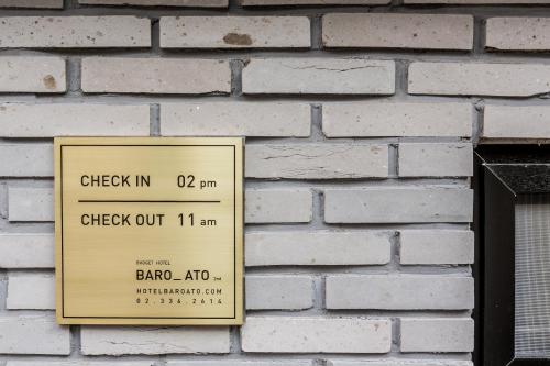 a sign on the side of a brick wall at Hotel Baroato 2nd in Seoul