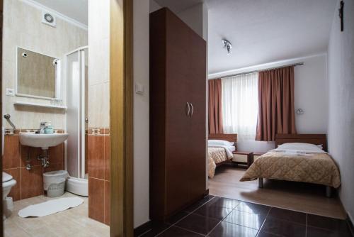 a hotel room with a bed and a bathroom at Hotel No-1 in Međugorje