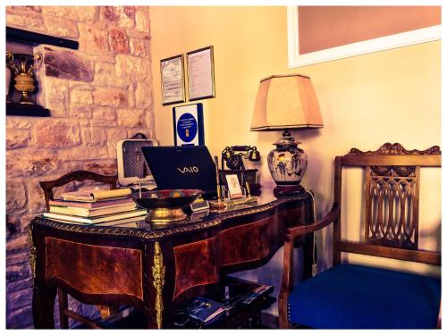 a room with a desk with a laptop and books at 4 Seasons in Vizitsa in Vizitsa