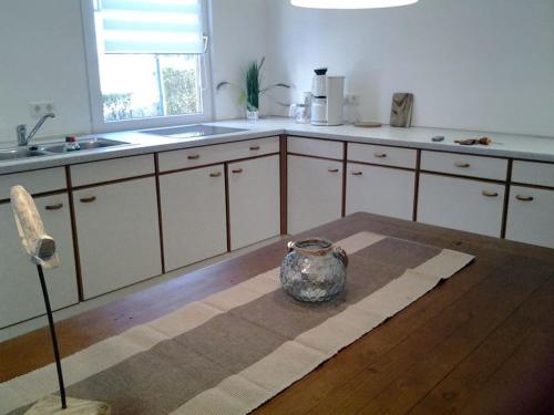 a kitchen with a vase sitting on a table at Haus Irma in Zingst