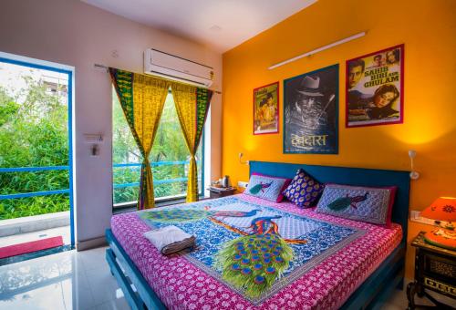 a bedroom with a bed with a colorful bedspread at The Coral Tree Boutique Homestay in Agra
