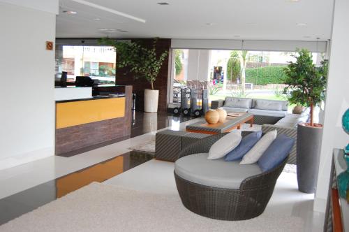 a living room with a couch and a table at Veredas do Rio Quente Flat in Rio Quente