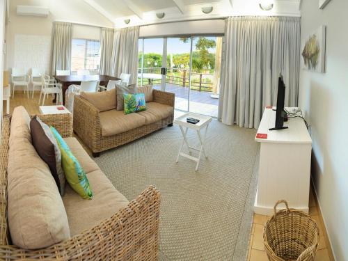 a living room with a couch and a table at Addo River-View Lodge in Colchester