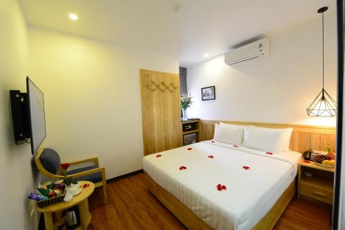 a hotel room with a bed and a television at Blue Hanoi Inn Luxury Hotel in Hanoi