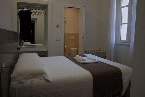 a bedroom with a bed with two towels on it at La Corte sul Naviglio in Boffalora sopra Ticino
