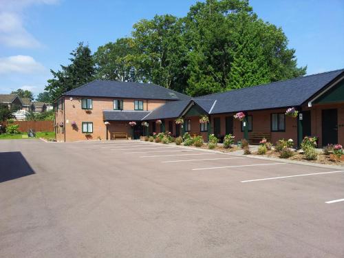 a large parking lot in front of a building at Deangate Motel in Lydney