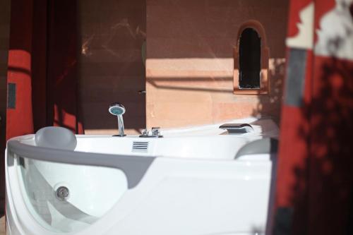 a white sink in a room with a mirror at La Maison Arabe Hotel, Spa & Cooking Workshops in Marrakech