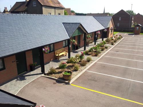 an empty parking lot with a row of buildings at Deangate Motel in Lydney