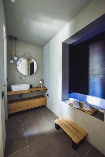 a bathroom with a sink and a mirror at Marquise Suites - Adults Only in Fira