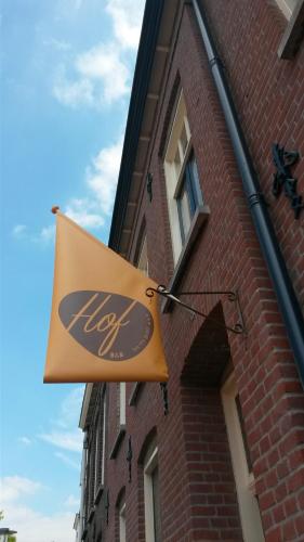a sign on the side of a brick building at Hof, a luxury B&B in the center of Eindhoven in Eindhoven