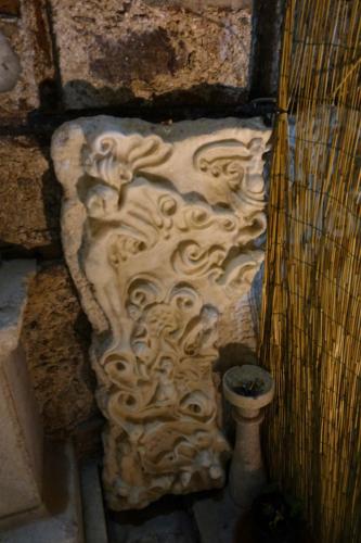 a stone sculpture on the side of a wall at Villa Cosilinum in Padula