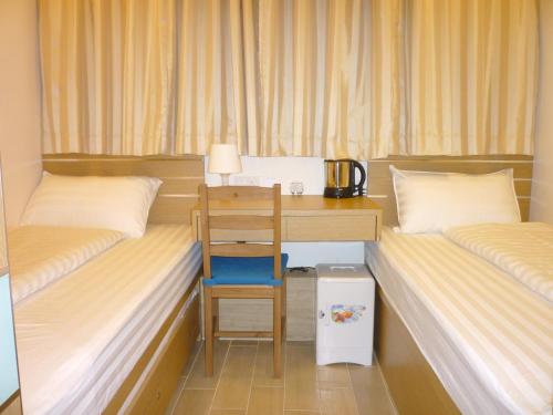 Voodi või voodid majutusasutuse Causeway Bay Inn (@Percival Street) toas