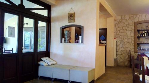 a room with a bench in front of a door at Agriturismo Casale Sera in Fontana Liri