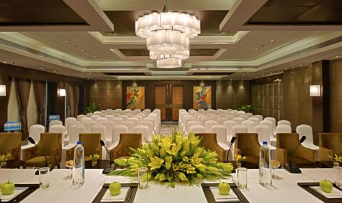 a banquet hall with white tables and chairs and a chandelier at Fortune District Centre, Ghaziabad - Member ITC Hotels' Group in Ghaziabad