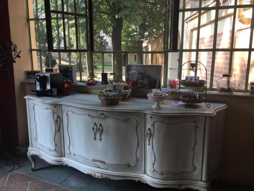 a large white cabinet in a room with windows at B&B San Martino in Mede