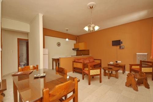 a living room with a table and a dining room at Hotel Marialena in Ancient Epidavros
