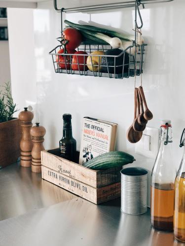 a kitchen counter with cook books and a basket of food at AVLiving City LOFT Basel in Basel