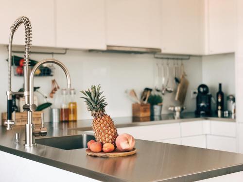 a pineapple sitting on a counter in a kitchen at AVLiving City LOFT Basel in Basel