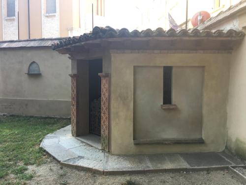 a building with a door with a cross on it at B&B San Martino in Mede