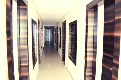 a hallway with a row of wine racks in a building at Hotel Gokul in Kota