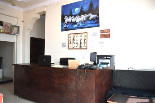a lobby with a reception desk with a phone at Hotel Gokul in Kota