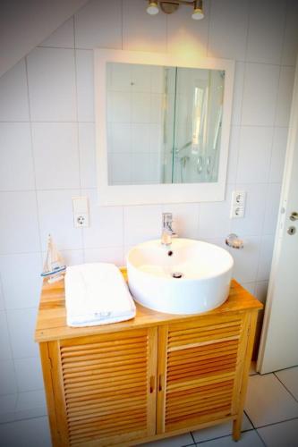 a bathroom with a sink and a mirror at Kieler FeWo No.1 in Kiel