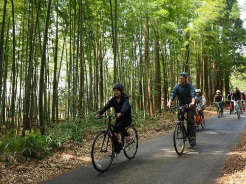 a group of people riding bikes down a road at Sendai Royal Park Hotel in Sendai