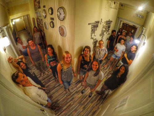 a group of people posing for a picture in a room at Victoria House Hostel in Genova