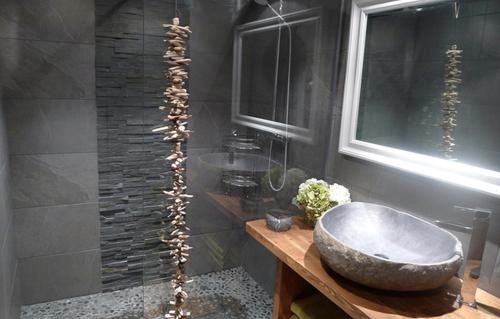 a bathroom with a large stone sink and a shower at Odalys Chalet Les Alpages in Les Deux Alpes